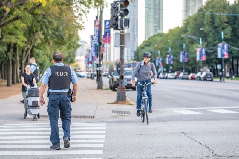 police officer walks along a street downtown